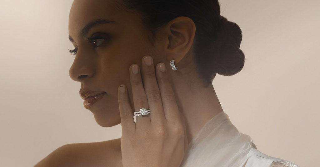 model posing with earring and two rings