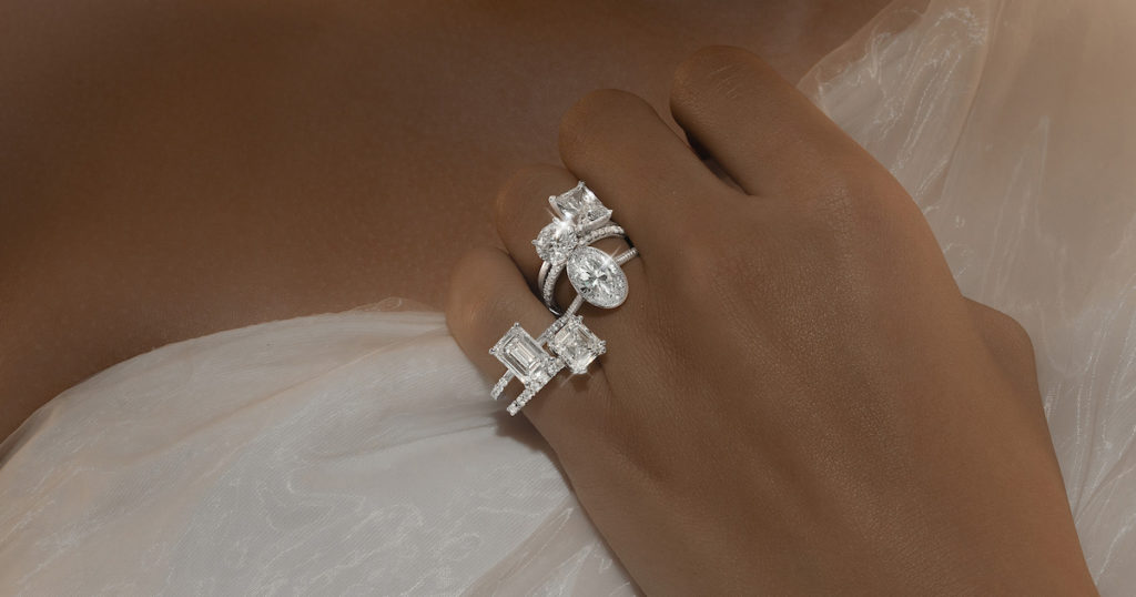 female model posing with multiple diamond rings