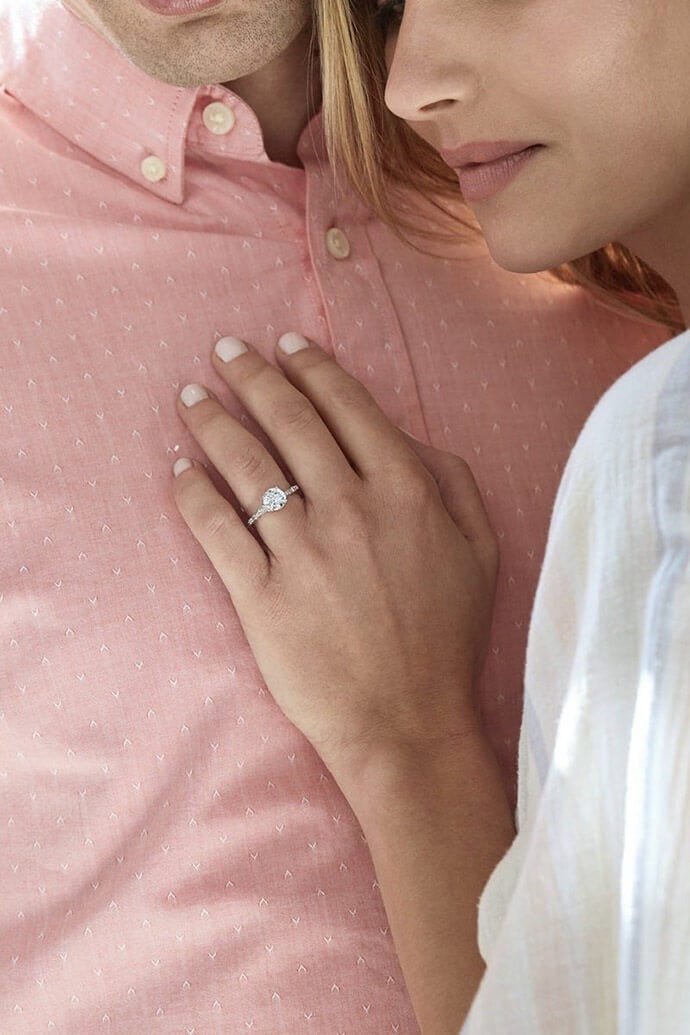 woman wearing man made diamond engagement ring