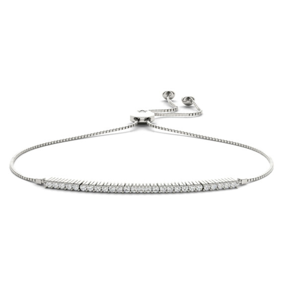“Adjustable bolo bracelet with a single row of ⅓ carat lab-grown diamonds set in polished metal.”